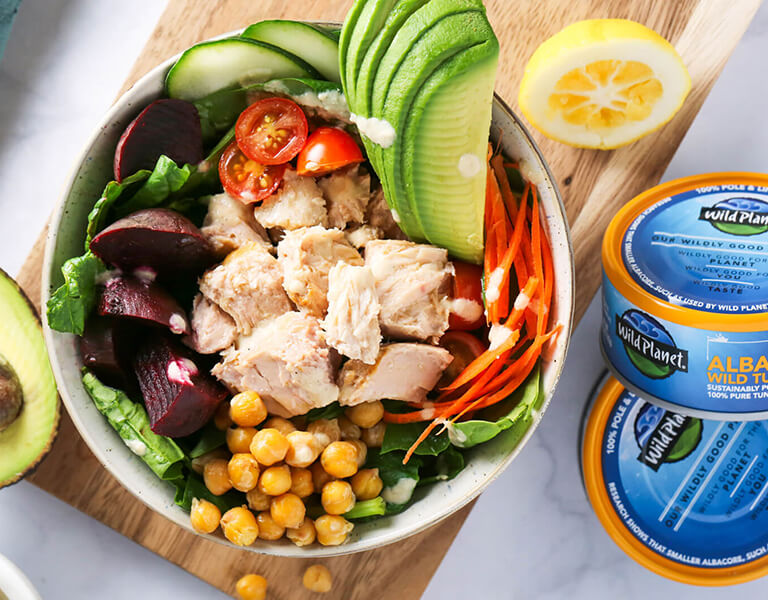 A Tuna Salad Bowl with Avocado, partially showing 2 cans of Albacore Tuna